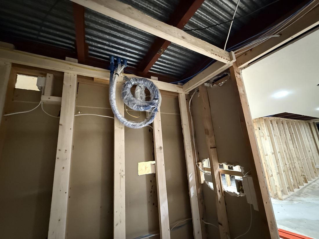 Low-voltage cable bundle bagged and coiled overhead during a Sioux Falls pre-wire