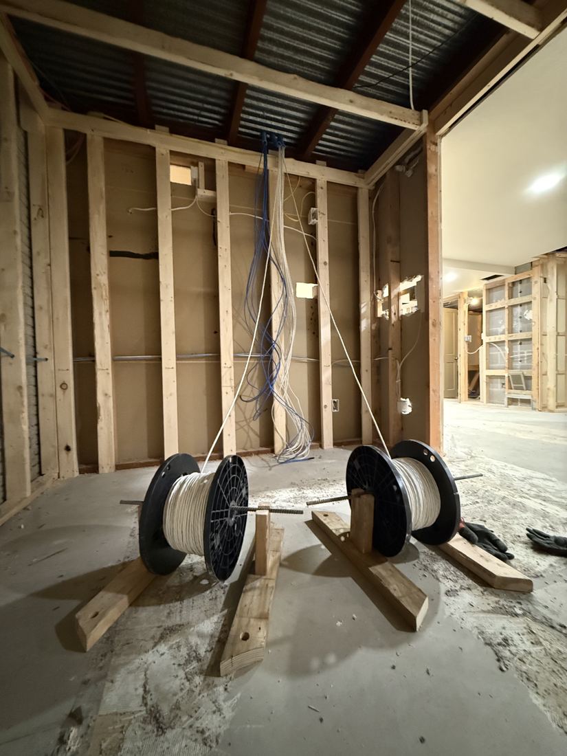 Low-voltage cable pulled from spools to a central drop in Sioux Falls new construction