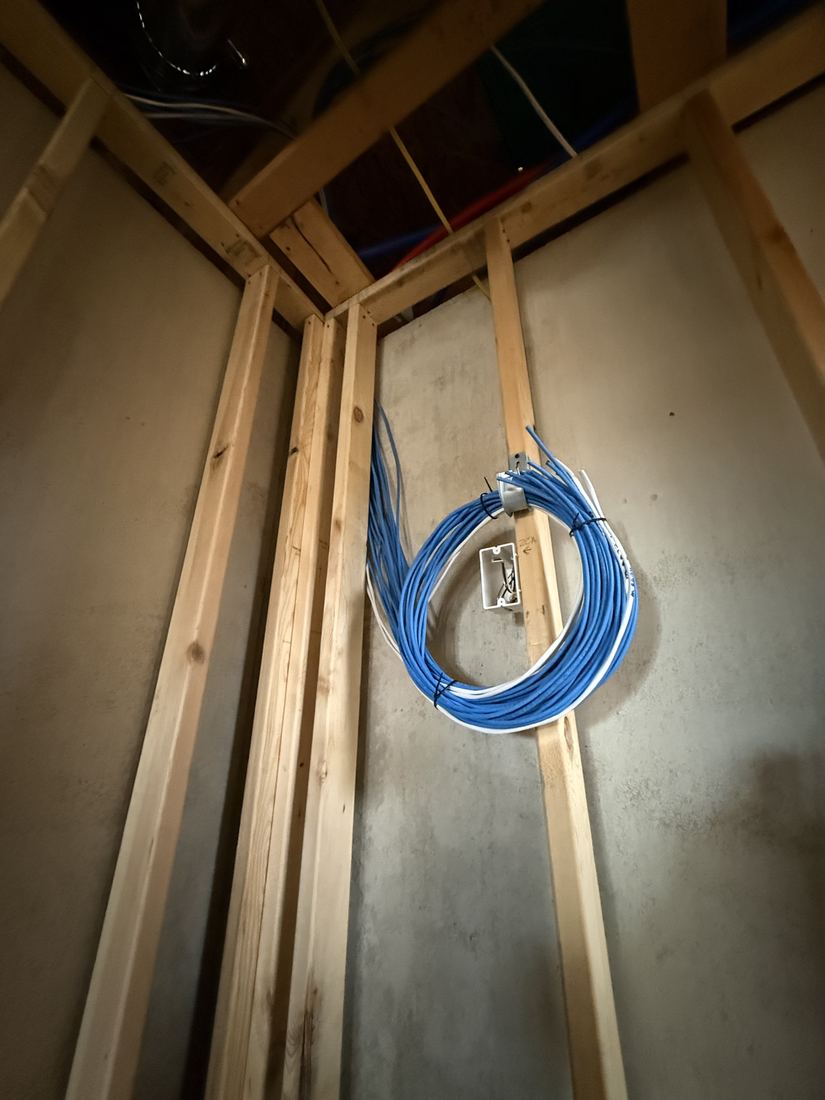 Cat6 network cable runs coiled at the panel location in a new Sioux Falls home